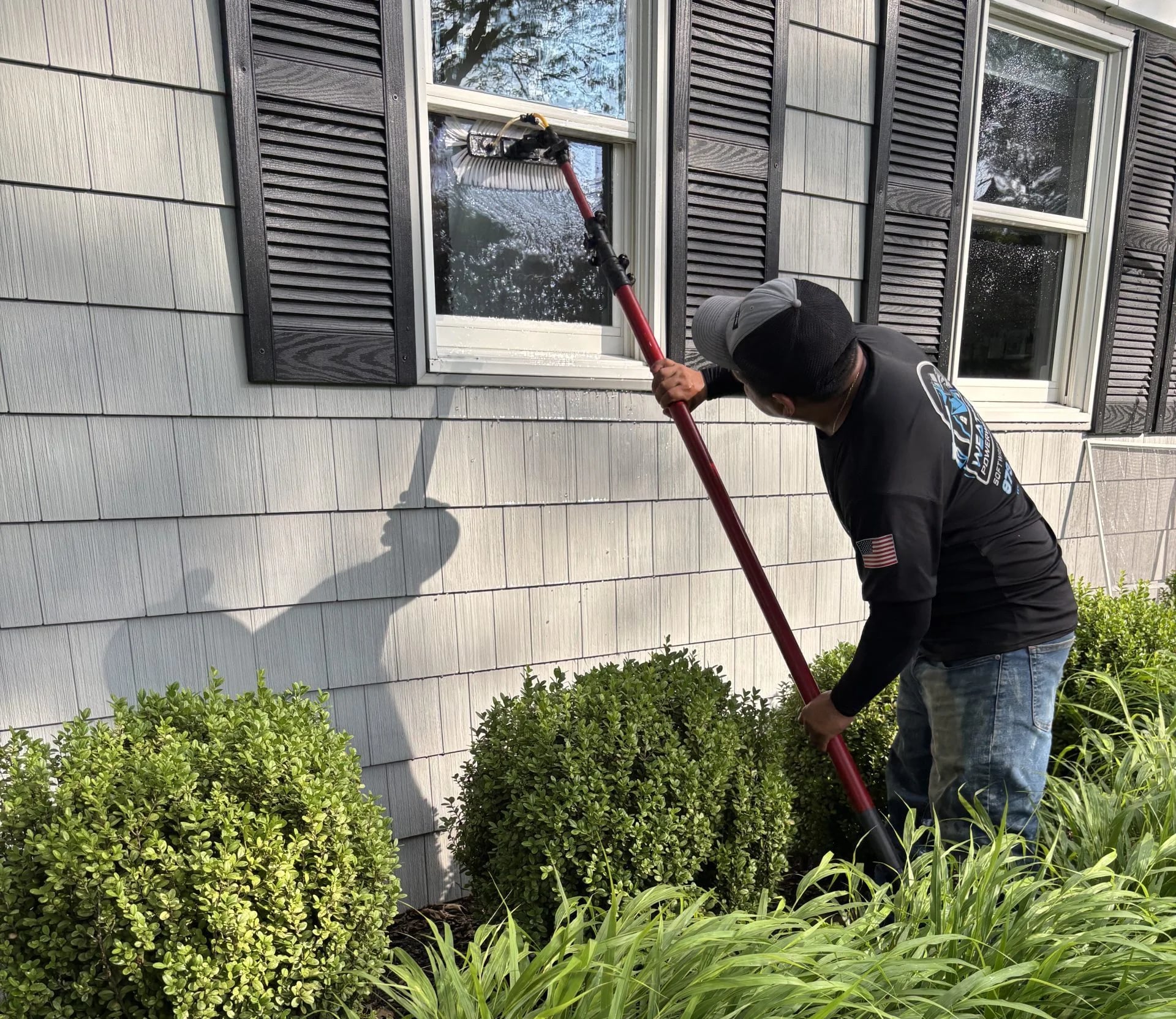 WeatherX technician soft washing cedar siding on a Morris County home