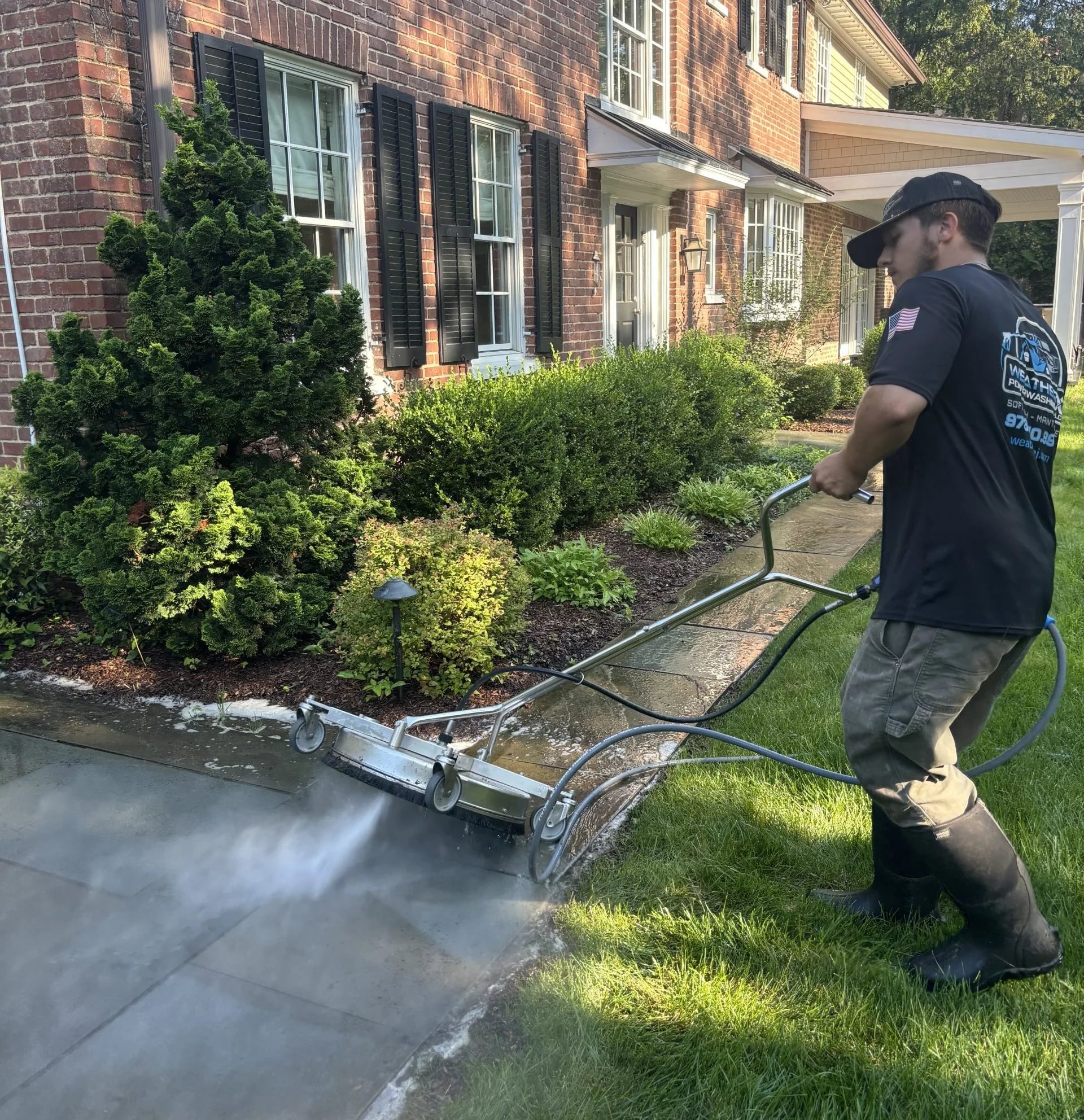 WeatherX technician surface-cleaning a residential walkway