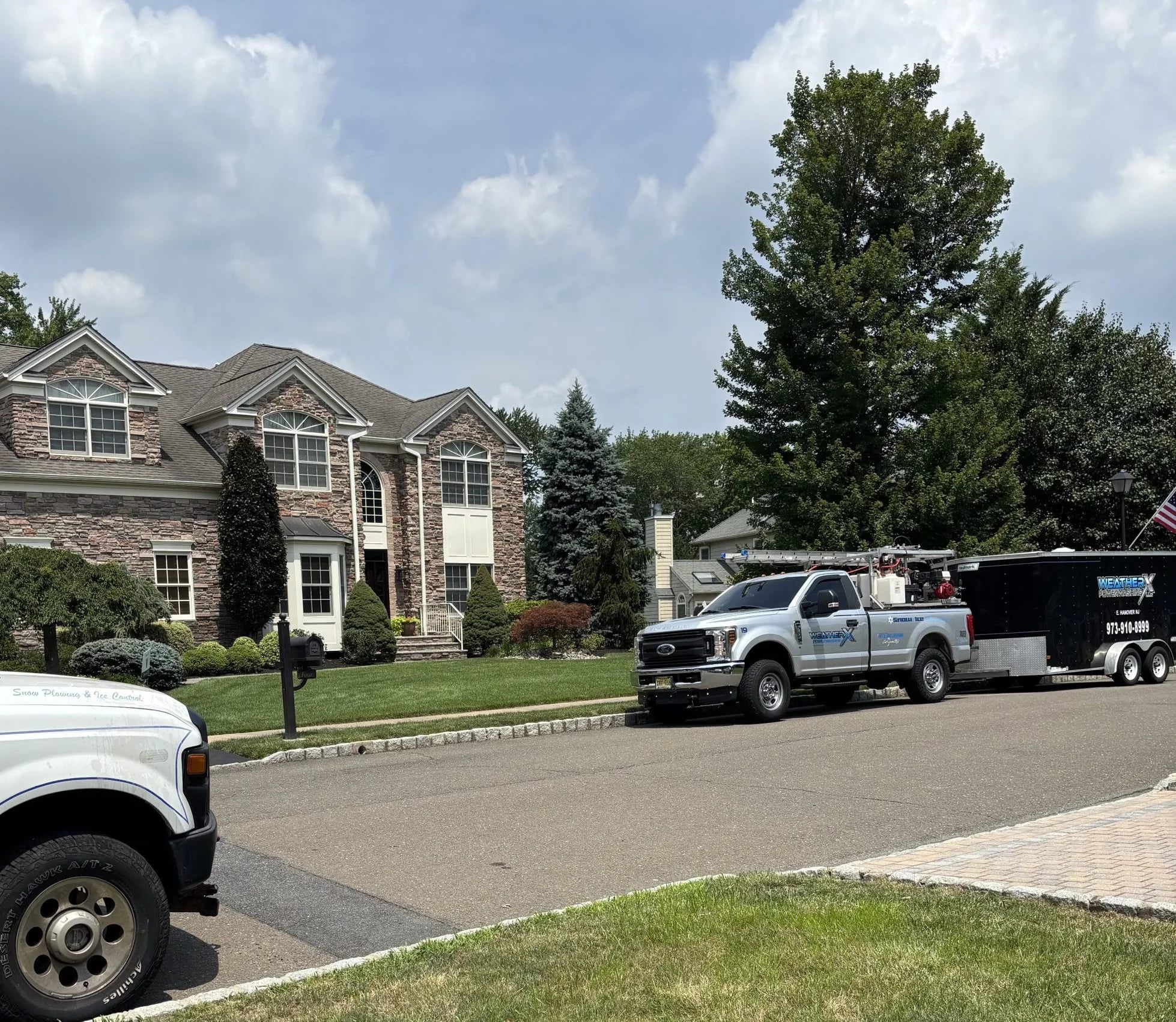 WeatherX trucks staged at a residential job